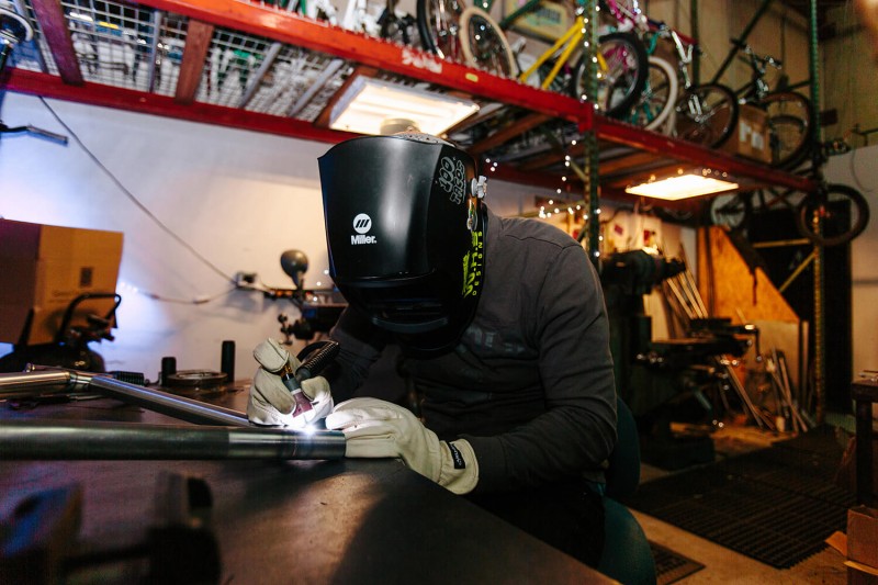 Brad Hodges of W.H. Bradford Design welding a bike frame. Photo by Angel Perez
