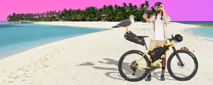 Cyclist, photoshopped onto an island landscape, stands with a bike alongside a seagull.